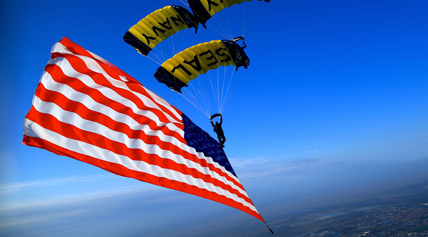 Navy seal parachuting with American flag